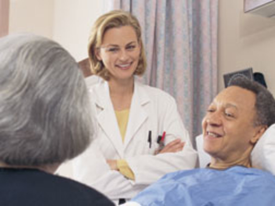 doctor talking to man hospital bed