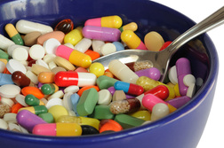 a spoon in a bowl of colourful vitamins.