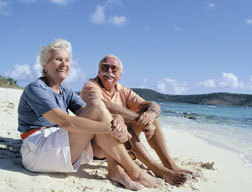 picture of a older man and woman sitting on a beach