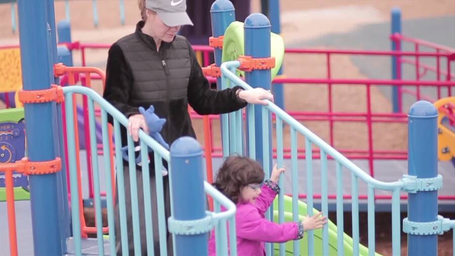 little girl with Mom at a play area