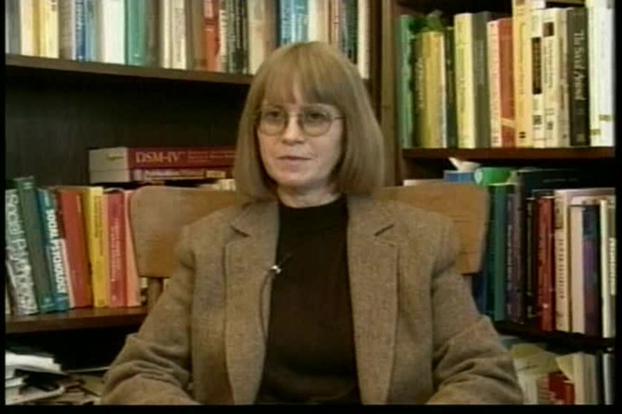 woman at a desk with lots of books