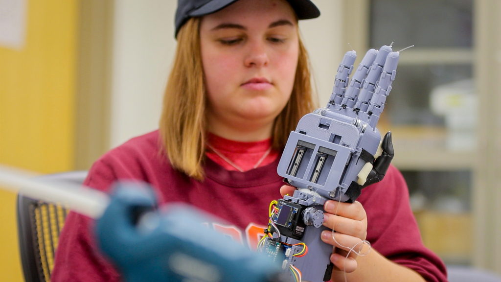 Students provide a helping hand to a young woman in need